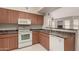 Functional kitchen featuring a breakfast bar and modern appliances at 14250 W Wigwam Blvd # 2111, Litchfield Park, AZ 85340