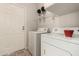 Functional laundry area with white appliances and storage shelf near the door at 14250 W Wigwam Blvd # 2111, Litchfield Park, AZ 85340