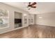 Open concept living room featuring built-in entertainment niche and wood-look flooring at 14250 W Wigwam Blvd # 2111, Litchfield Park, AZ 85340
