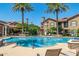 Community swimming pool with lounge chairs and well-maintained landscaping, perfect for relaxation at 14250 W Wigwam Blvd # 2111, Litchfield Park, AZ 85340