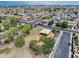 Aerial view of a neighborhood with lush green trees, houses, and streets with sidewalks showing an active community at 14554 W Evans Dr, Surprise, AZ 85379