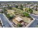 Bird's-eye view of a neighborhood park with playground, mature trees, and well-maintained landscape at 14554 W Evans Dr, Surprise, AZ 85379