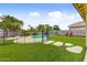Landscaped backyard with a pool, artificial turf, mature landscaping and stepping stones at 14554 W Evans Dr, Surprise, AZ 85379