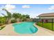 Backyard featuring a freeform swimming pool surrounded by concrete and artificial turf at 14554 W Evans Dr, Surprise, AZ 85379