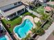Aerial view of a backyard pool with artificial grass, covered patio, and a secure fence for relaxation and safety at 14554 W Evans Dr, Surprise, AZ 85379