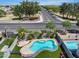 Aerial view of backyard pool with artificial grass, covered patio, and community street at 14554 W Evans Dr, Surprise, AZ 85379