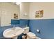 Stylish half-bathroom with blue wainscoting, modern sink and fixtures, and tasteful decor at 14554 W Evans Dr, Surprise, AZ 85379