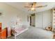 Spacious bedroom with neutral walls, ceiling fan and carpet, plus a walk-in closet for ample storage at 14554 W Evans Dr, Surprise, AZ 85379