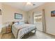 Cozy bedroom featuring a comfortable queen bed, neutral tones, and natural light from a window at 14554 W Evans Dr, Surprise, AZ 85379