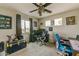 Spacious bedroom offering natural light, carpet flooring, a ceiling fan, and a workspace at 14554 W Evans Dr, Surprise, AZ 85379