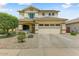 Inviting two-story home with a well-manicured front yard and a spacious two-car garage at 14554 W Evans Dr, Surprise, AZ 85379