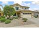 Charming two-story home boasts a well-maintained landscaped front yard and inviting curb appeal at 14554 W Evans Dr, Surprise, AZ 85379