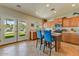 Bright kitchen with wood cabinets, tiled floors, stainless steel appliances and bar seating at 14554 W Evans Dr, Surprise, AZ 85379