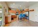 Open kitchen featuring wood cabinets, stainless steel appliances, tiled floors and a large island at 14554 W Evans Dr, Surprise, AZ 85379