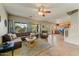Open-concept living room with tiled floor, comfortable seating, and lots of natural light at 14554 W Evans Dr, Surprise, AZ 85379