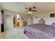 Serene main bedroom featuring carpeted flooring, a ceiling fan, and access to ensuite bath and walk-in closet at 14554 W Evans Dr, Surprise, AZ 85379