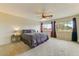 Spacious main bedroom with large windows, carpeted floors, and neutral walls, flooded with natural light at 14554 W Evans Dr, Surprise, AZ 85379