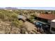Aerial view of a pool and horse stables on a desert property with mountain views at 1500 N Crismon Rd, Mesa, AZ 85207