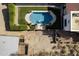 A high-angle aerial image showcasing a home's pool, lush greenery, and surrounding desert landscape at 1500 N Crismon Rd, Mesa, AZ 85207