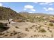 Expansive aerial view of a desert home with a horse arena and stunning mountain backdrop at 1500 N Crismon Rd, Mesa, AZ 85207