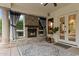 Inviting back patio with stone fireplace, neutral rug, decorative potted plants and access to the yard at 1500 N Crismon Rd, Mesa, AZ 85207