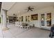 Expansive covered patio with a stone fireplace and dining area, perfect for outdoor entertaining at 1500 N Crismon Rd, Mesa, AZ 85207