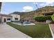 Expansive backyard with a sparkling pool, lush green lawn, and a charming, well-manicured landscape at 1500 N Crismon Rd, Mesa, AZ 85207
