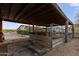 Well-maintained barn with sturdy metal structures, situated in a picturesque outdoor setting at 1500 N Crismon Rd, Mesa, AZ 85207