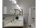 Bright bathroom featuring a dual sink vanity with marble countertop and shower with tub at 1500 N Crismon Rd, Mesa, AZ 85207