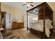 Cozy bedroom featuring a four-poster bed, hardwood floors, and a traditional ceiling fan at 1500 N Crismon Rd, Mesa, AZ 85207