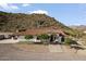 An appealing ranch-style home featuring a red tile roof, a grand staircase, and desert landscaping at 1500 N Crismon Rd, Mesa, AZ 85207