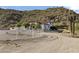 Extensive desert property with a beautiful home and a white fence outlining the perimeter of the property at 1500 N Crismon Rd, Mesa, AZ 85207