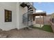 Home exterior has spiral staircase, gravel, synthetic grass, and covered patio at 1500 N Crismon Rd, Mesa, AZ 85207