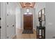 Grand foyer with a high, decorative ceiling, hardwood floors, and a rustic wooden door, enhanced by wall art at 1500 N Crismon Rd, Mesa, AZ 85207