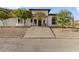 Stunning front exterior of a two-story home with a grand entrance, beautiful landscaping, and a concrete staircase at 1500 N Crismon Rd, Mesa, AZ 85207