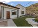Exterior of a home showcasing a pool, manicured lawn, tile roof, and well-maintained landscaping at 1500 N Crismon Rd, Mesa, AZ 85207