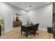 Bright home office features custom desk and bookcase, hardwood floors, and a connecting sitting room at 1500 N Crismon Rd, Mesa, AZ 85207