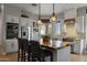 Bright and open kitchen with white cabinetry, a spacious island, and stainless steel appliances at 1500 N Crismon Rd, Mesa, AZ 85207