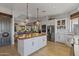 A modern kitchen features a butcher block island, white cabinets, and stainless steel appliances at 1500 N Crismon Rd, Mesa, AZ 85207