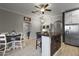 Bright kitchen has a dining table, white cabinets, and a stainless steel refrigerator at 1500 N Crismon Rd, Mesa, AZ 85207