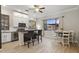 Eat-in kitchen with island seating, stainless appliances, and a view to the outside at 1500 N Crismon Rd, Mesa, AZ 85207
