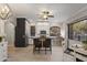 Open kitchen featuring white cabinets, a dark island, tile flooring, stainless appliances and plenty of light at 1500 N Crismon Rd, Mesa, AZ 85207