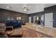 Spacious living room features a plush blue sofa, hardwood floors, leather chairs and a decorative rug at 1500 N Crismon Rd, Mesa, AZ 85207