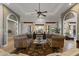 This living room offers two sofas, a ceiling fan, and access to multiple patios at 1500 N Crismon Rd, Mesa, AZ 85207