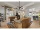 A spacious living room features hardwood floors, modern furniture, and a piano at 1500 N Crismon Rd, Mesa, AZ 85207