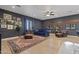 Relaxing living room features a plush blue sofa, hardwood floors, leather chairs and a decorative rug at 1500 N Crismon Rd, Mesa, AZ 85207