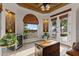 Bright living room features light wood floors, statement ceiling, and large windows with access to the exterior at 1500 N Crismon Rd, Mesa, AZ 85207