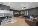 Spacious living room features a wet bar, plush blue sofa, hardwood floors, leather chairs and a decorative rug at 1500 N Crismon Rd, Mesa, AZ 85207