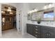 The main bathroom boasts double sinks, vanity, and a walk-in closet with a chandelier at 1500 N Crismon Rd, Mesa, AZ 85207