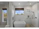 Bright main bathroom features a white tub and shower with tiled walls and a window view at 1500 N Crismon Rd, Mesa, AZ 85207